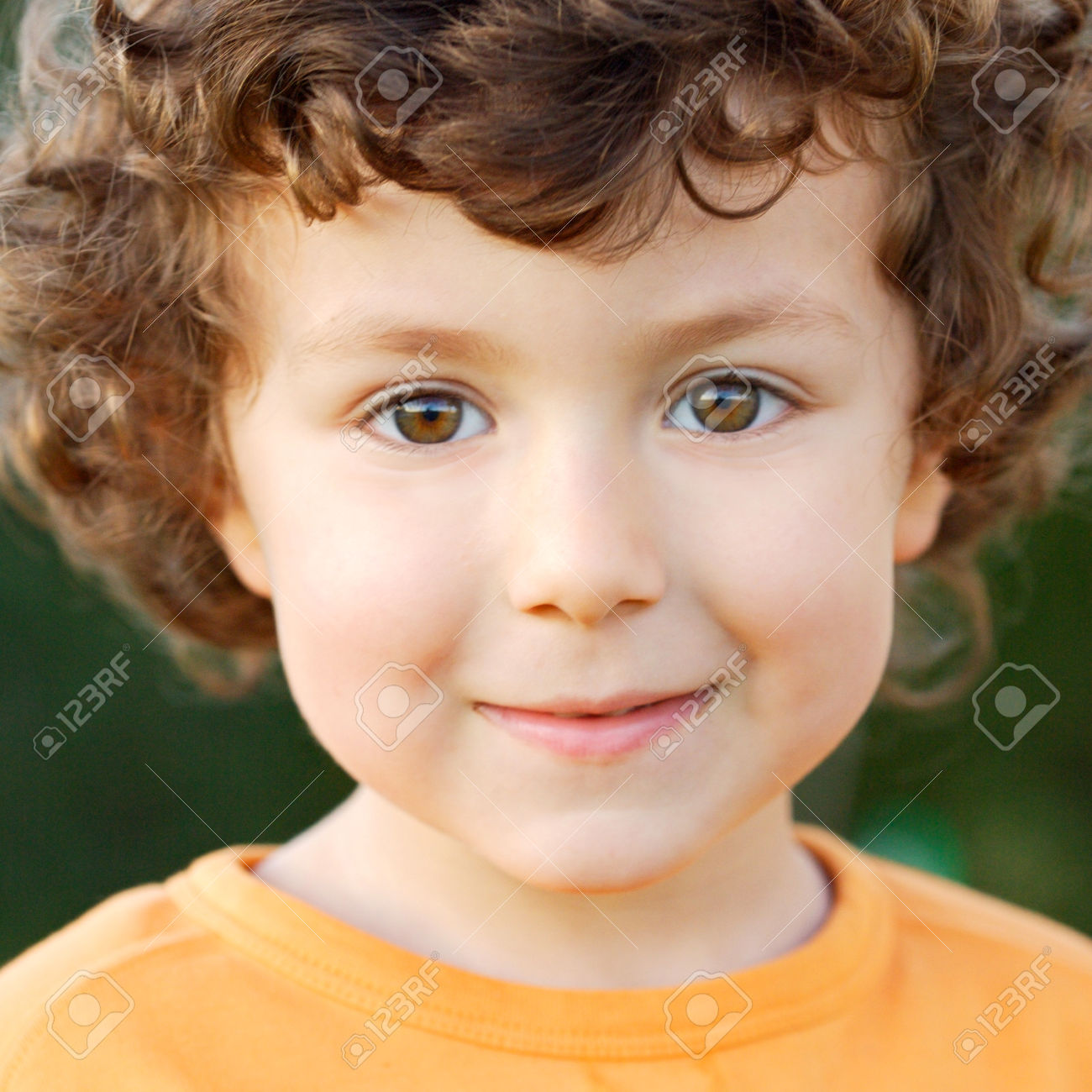 46800490 Nice portrait of a little boy with curly hair and brown eyes Stock Photo